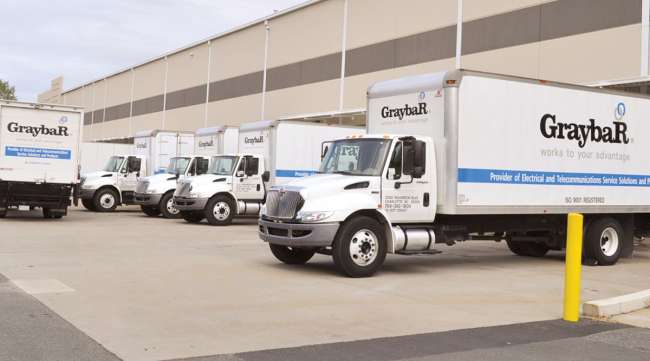 Compliance-GreybaR-Trucks.jpg Graybar trucks parked at a loading dock