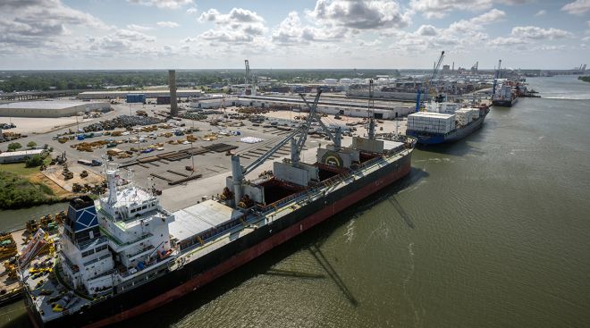 Three vessels work to load and unload cargo