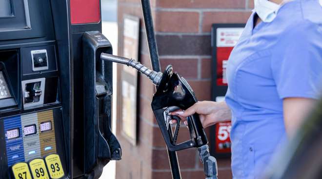 Getty Image of a woman pumping gas