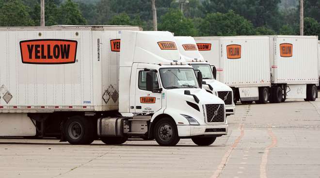 Yellow trucks and trailers at terminal